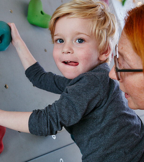 Picture: Under supervision and with assistance, a physiotherapist practices with a child on the climbing wall.