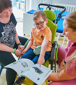 Picture: Therapist advises a mother and her son on the choice of aids.