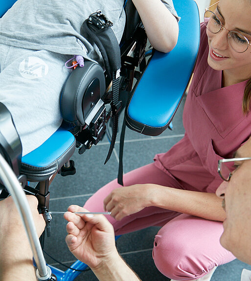 Picture: A rehab technician adjusts a patient's recliner chair