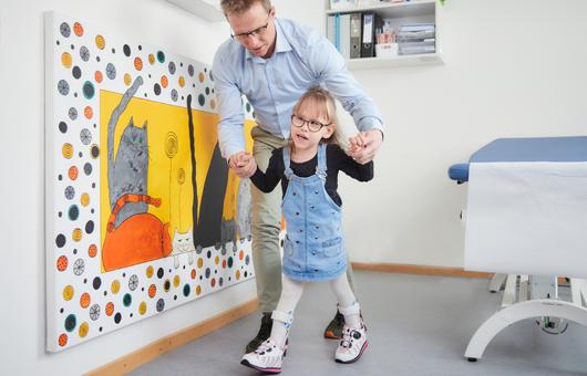Picture: A doctor checks the gait pattern of a small patient.