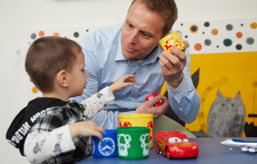 Picture: A doctor checks the state of health, the developmental stage and the play behaviour of a young patient