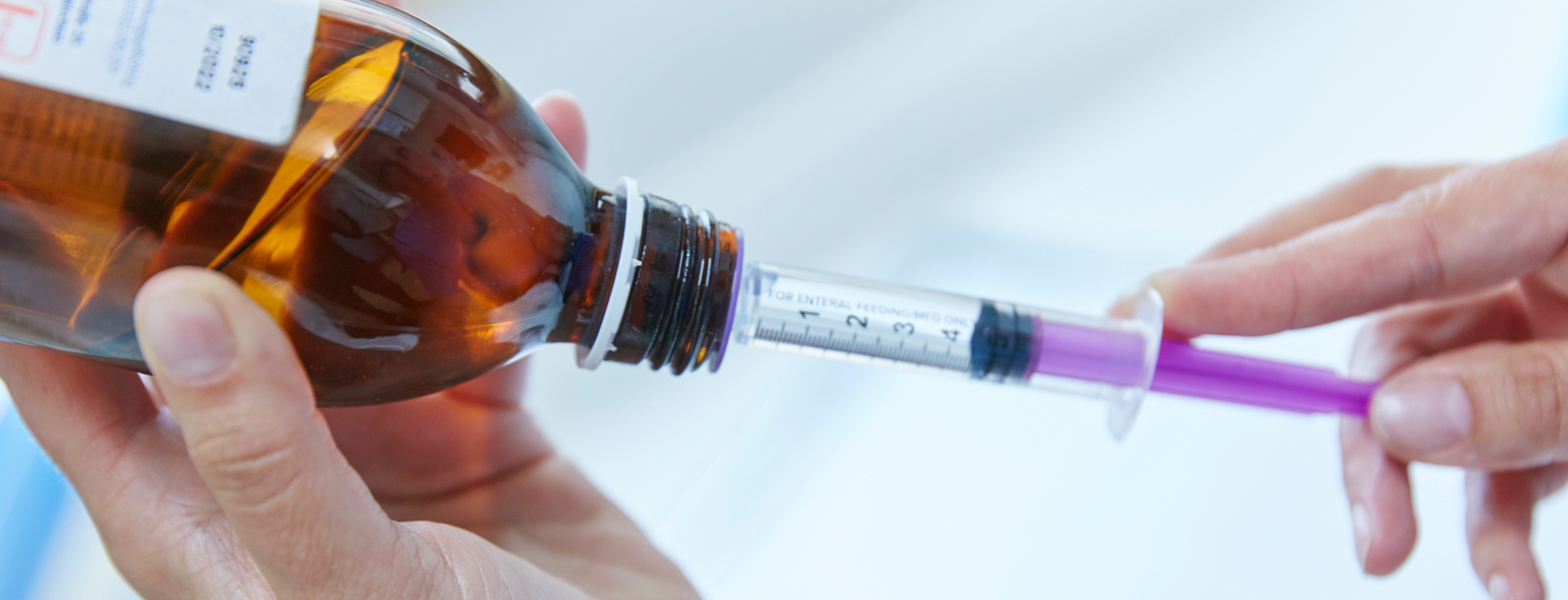 Preparation of a drug administration Picture: A nursing staff member prepares the administration of a medicine in juice form