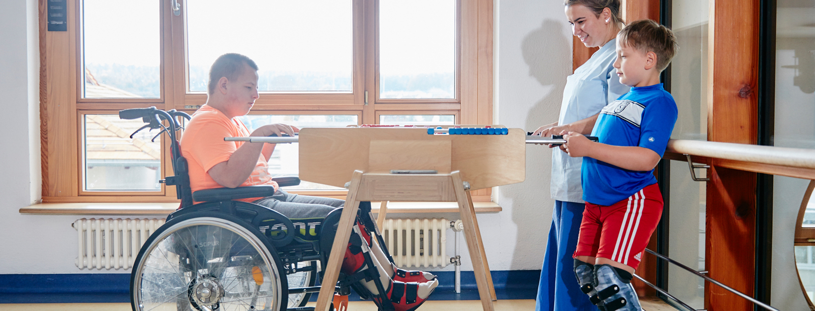 Picture: Children and their parents having fun playing a table football game